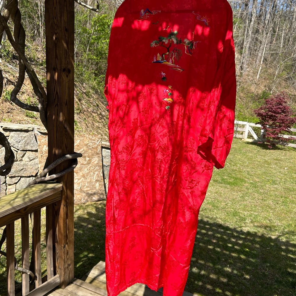 Red kimono with hand stitched embroidery. a bonsai tree, the sun and mountain